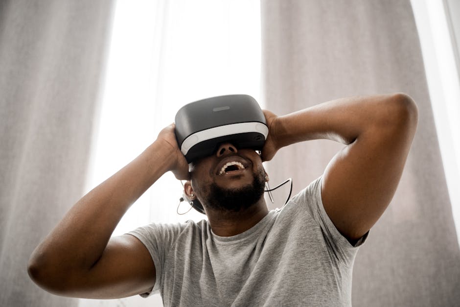 Smiling man with VR headset enjoying a virtual experience indoors, showcasing modern technology.